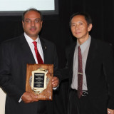 Maqsood Malik, P.E., President of M&J accepts the Best Business person of the Year Award 2013 from the South Asian American Association (SAAAI)